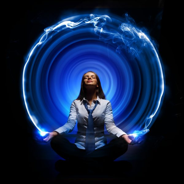 woman surrounded by a blue circle of energy with her eyes closed